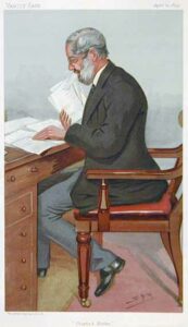 Colored image of a bearded man with glasses sitting on a chair at a desk looking through sheets of paper.