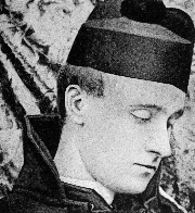 A black and white facial photographic portrait of Baron Corvo, turned to the left with side profile shown. Hat appears on top of head.
